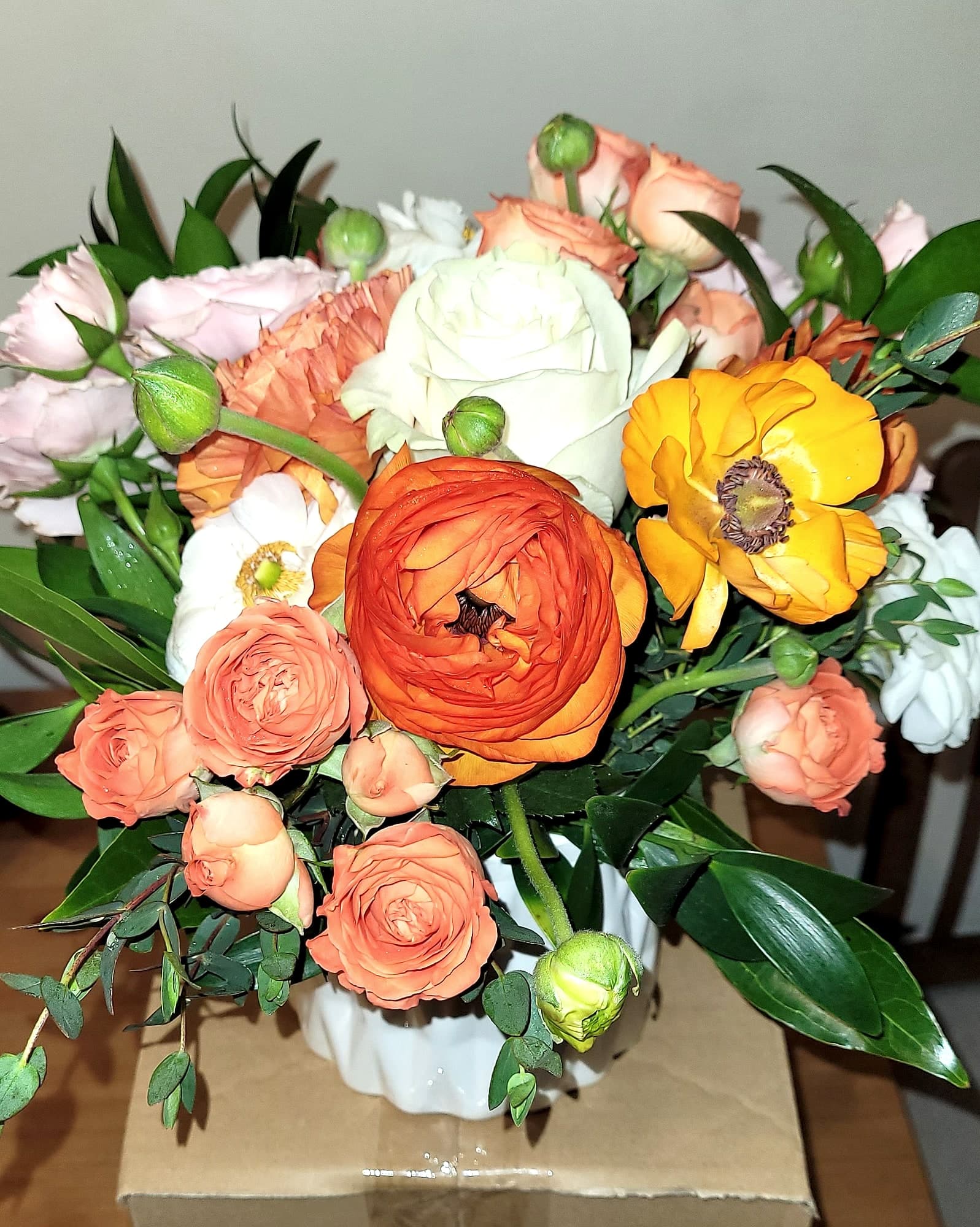 Autumn garden bouquet of orange ranunculus, garden roses, and eucalyptus by Build a Bouquet by Jenn