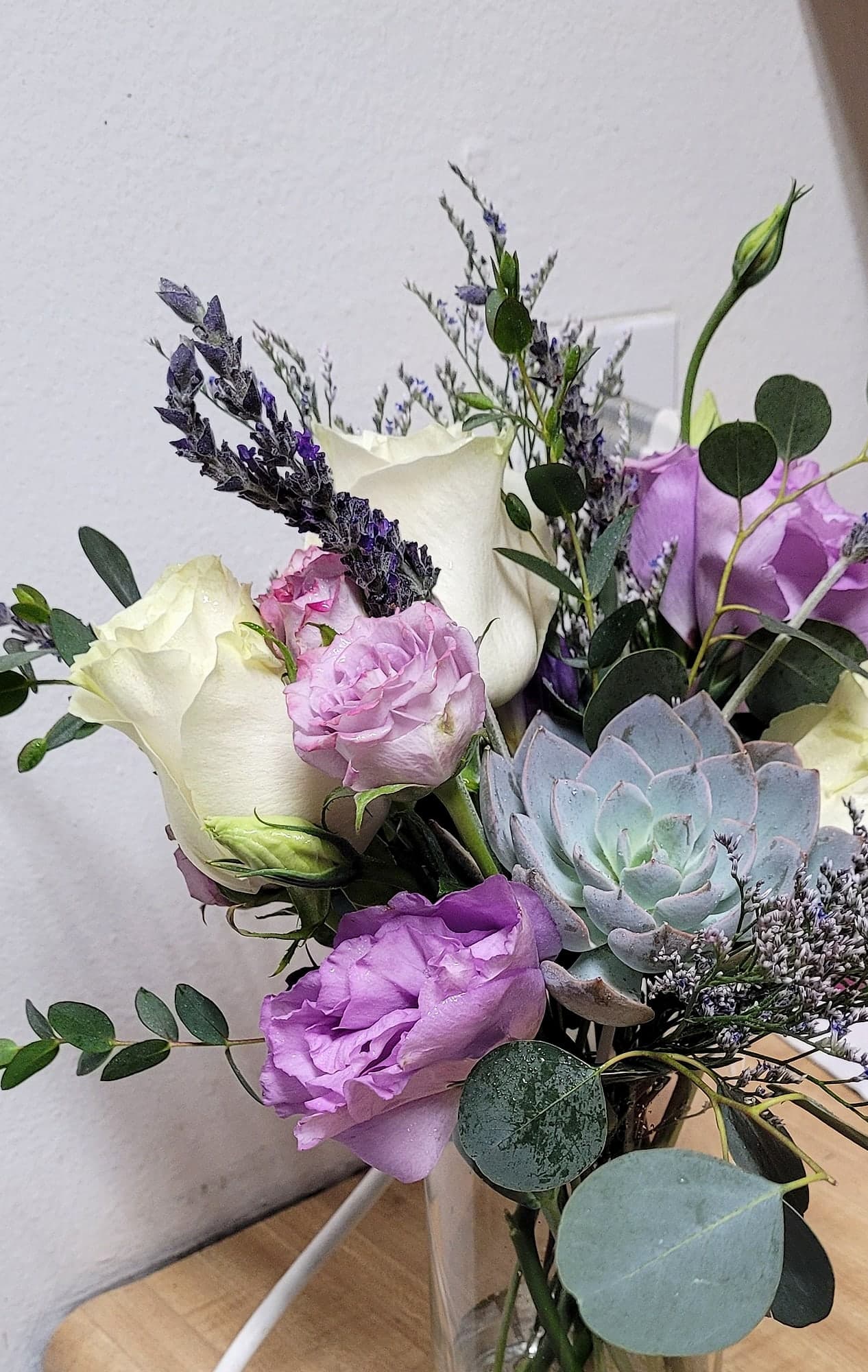 Lavender and white bouquet with a succulent, dried lavender, and eucalyptus.